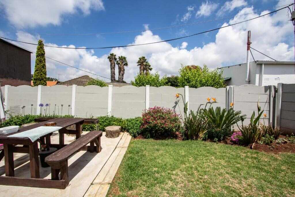 Garden with outdoor seating at Willow Guest House